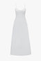 A long, white sleeveless summer dress with adjustable thin shoulder straps and a fitted bodice. Made from breathable stretch cotton, the Cami Fit And Flare Midi In White by Victoria Beckham has a smooth, flowing silhouette.