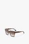 Rectangular tortoiseshell-patterned Soft Square Frame Sunglasses In Striped Khaki Havana with dark gradient lenses from Victoria Beckham, gracefully positioned on a plain white background.