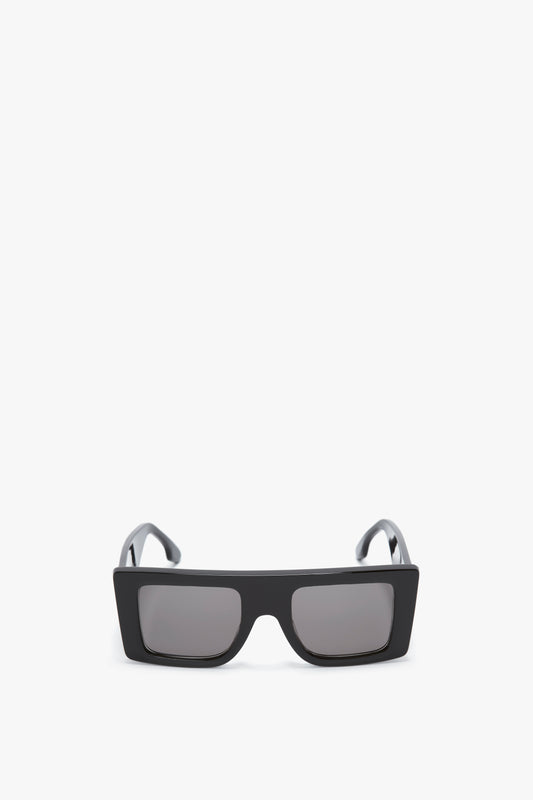 Oversized Frame Sunglasses In Black by Victoria Beckham, reminiscent of the latest SS24 runway trends, are displayed elegantly on a white background.