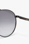 Close-up view of a pair of V Metal Pilot Sunglasses In Grey Gradient with a black metal frame and gunmetal grey gradient lenses, featuring "Victoria Beckham" inscribed on the temple.