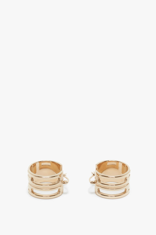A pair of Exclusive Frame Hoop Earrings In Gold by Victoria Beckham, placed on a white background.