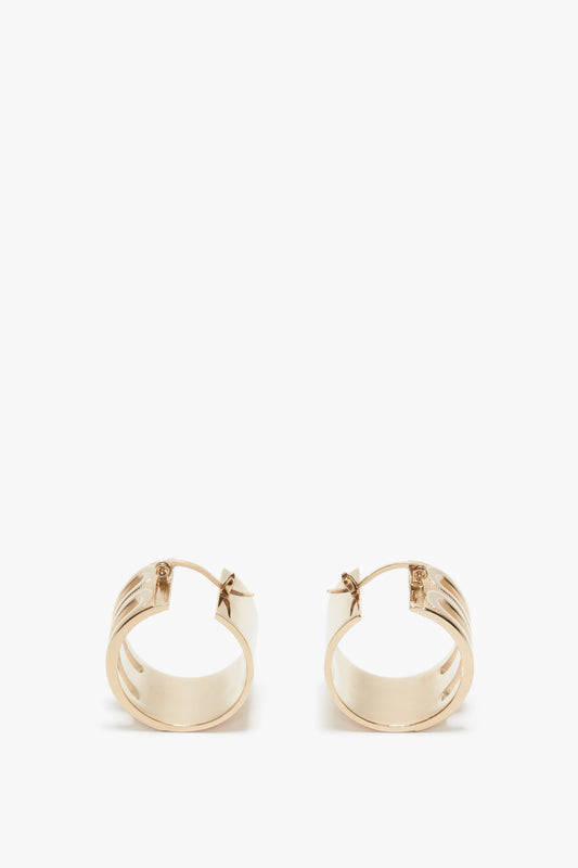 A pair of Exclusive Frame Hoop Earrings In Gold by Victoria Beckham, displayed against a white background.