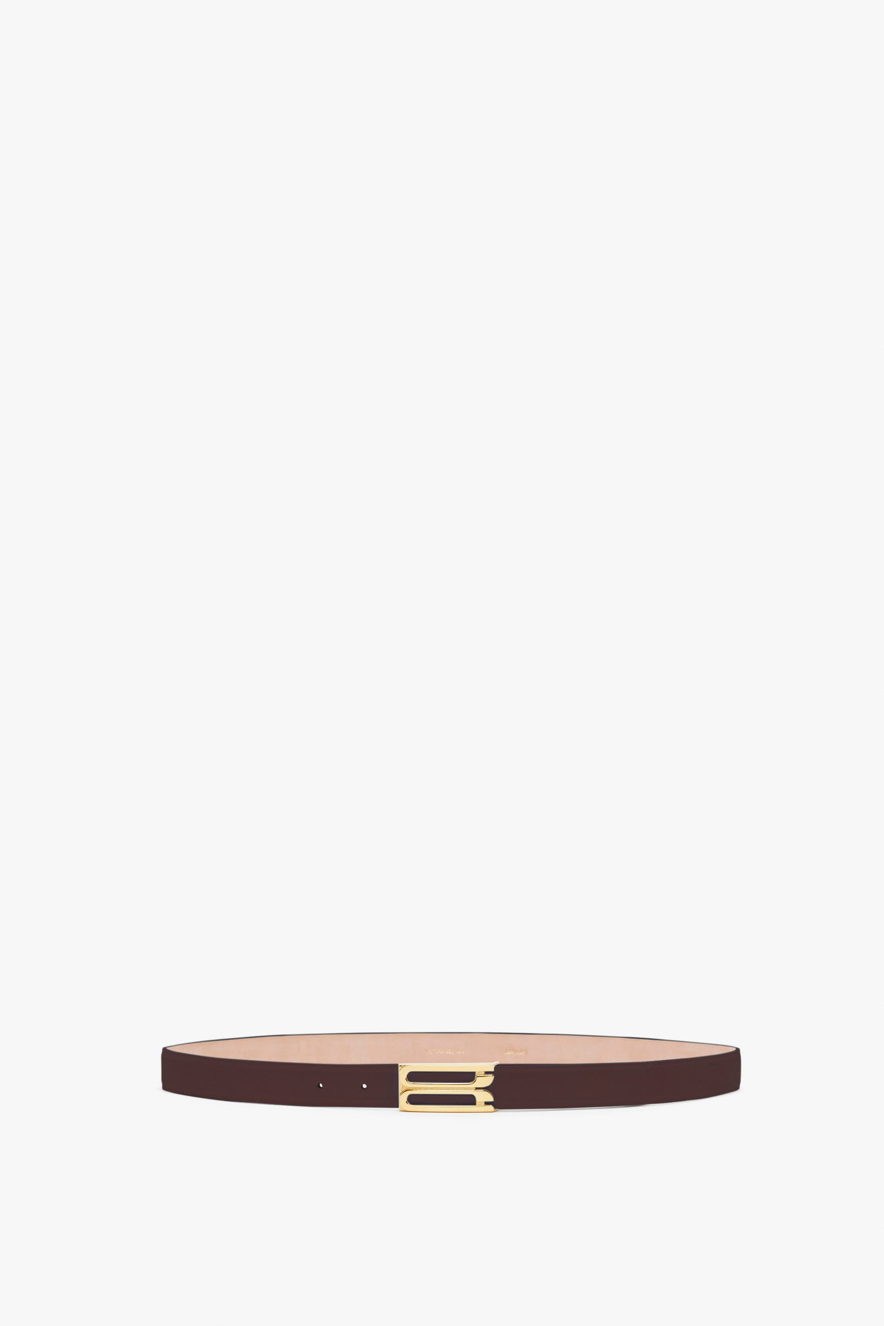 A thin Victoria Beckham Frame Belt In Burgundy Leather with gold hardware and a rectangular buckle displayed against a white background.