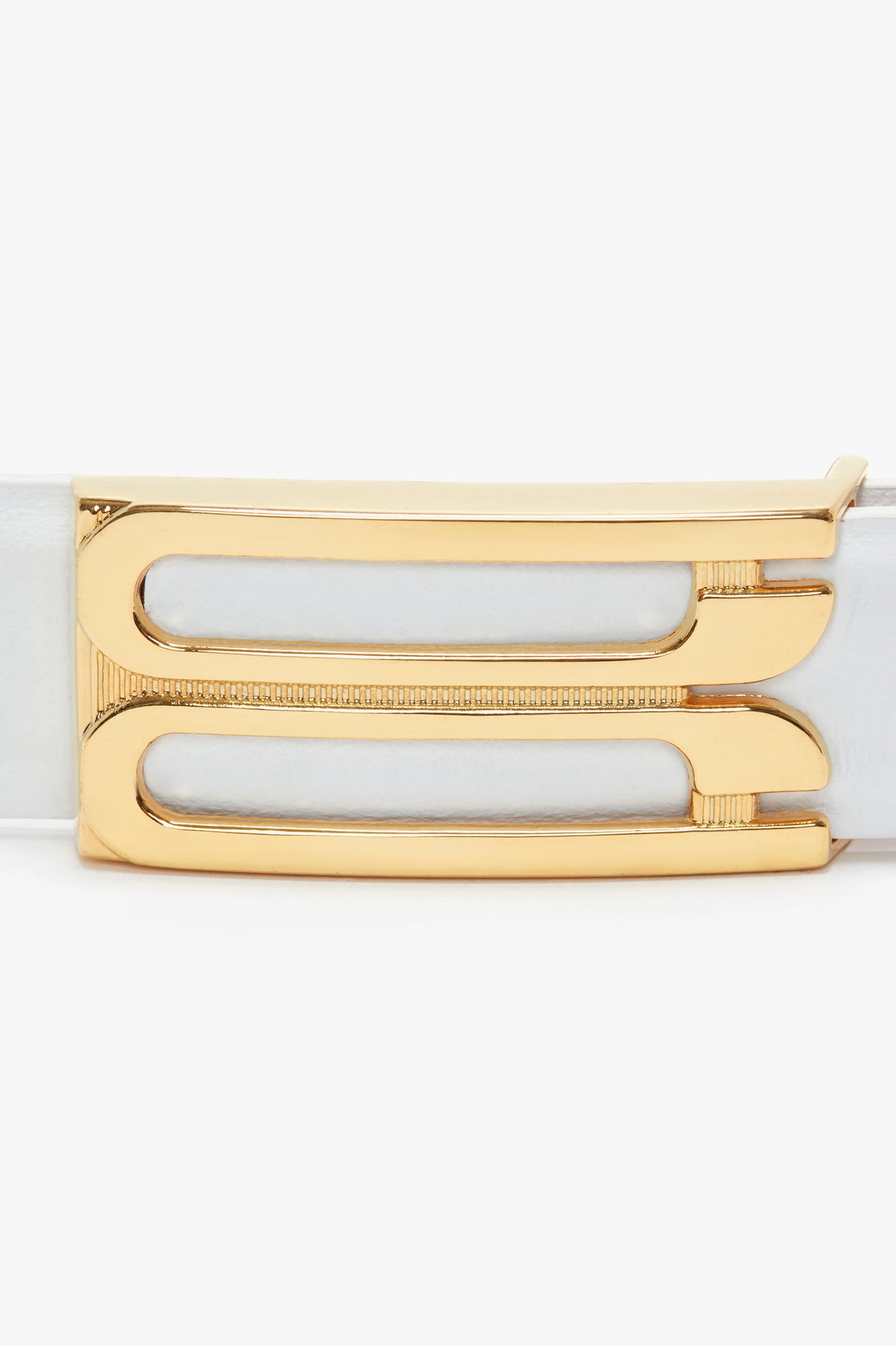 Close-up of a Frame Belt In White Leather by Victoria Beckham, made from polished white smooth calf leather, featuring a gold metal buckle with two elongated rectangular cutouts.