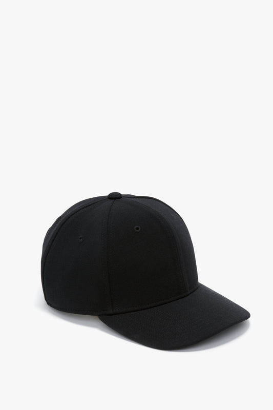 A plain black wool crepe Exclusive Logo cap in Black with a curved brim displayed against a white background by Victoria Beckham.