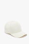 A plain Antique White Victoria Beckham logo cap isolated on a white background.