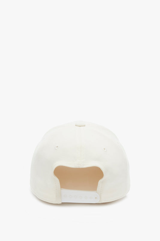Rear view of a Victoria Beckham Logo Cap in Antique White with an adjustable snap, isolated on a white background.