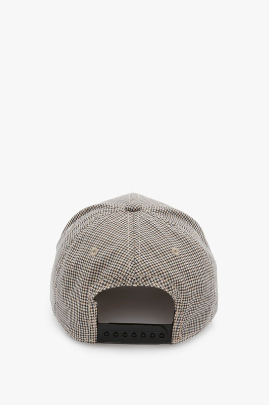Rear view of a Victoria Beckham Logo Cap In Dogtooth Check with an adjustable black snap, isolated on a white background.
