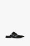 A single black Flat Lace Up Mules In Black Leather by Victoria Beckham, styled as an Oxford brogue, featuring a closed toe and open back with decorative perforations and laces, displayed against a white background.