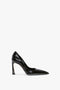 A single black high-heeled V Pump In Black Brushed Leather by Victoria Beckham with a pointed toe and glossy, brushed leather finish is displayed against a plain white background.