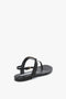 A Victoria Beckham Flat Chain Sandal In Black Leather with a flat sole and a thin, adjustable ankle strap featuring a small buckle, crafted from luxurious calfskin leather.