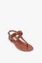 Single Flat Chain Sandal In Tan Leather by Victoria Beckham with a flat sole, adjustable ankle strap, and gold-tone chain detail on a white background.