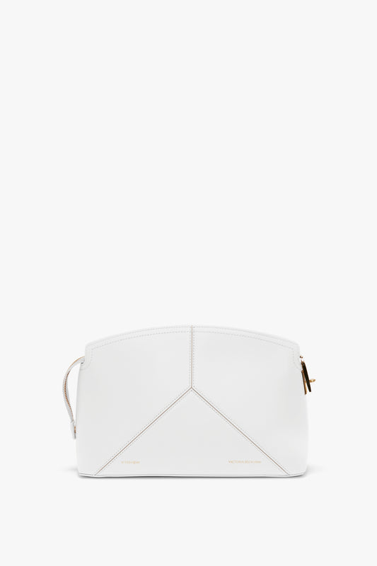 White leather handbag with a minimalist design, featuring gold-tone zipper hardware and subtle stitching details. This Victoria Beckham Exclusive Victoria Clutch Bag In White Leather embodies understated elegance and sophistication.