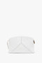 White leather handbag with a minimalist design, featuring gold-tone zipper hardware and subtle stitching details. This Victoria Beckham Exclusive Victoria Clutch Bag In White Leather embodies understated elegance and sophistication.