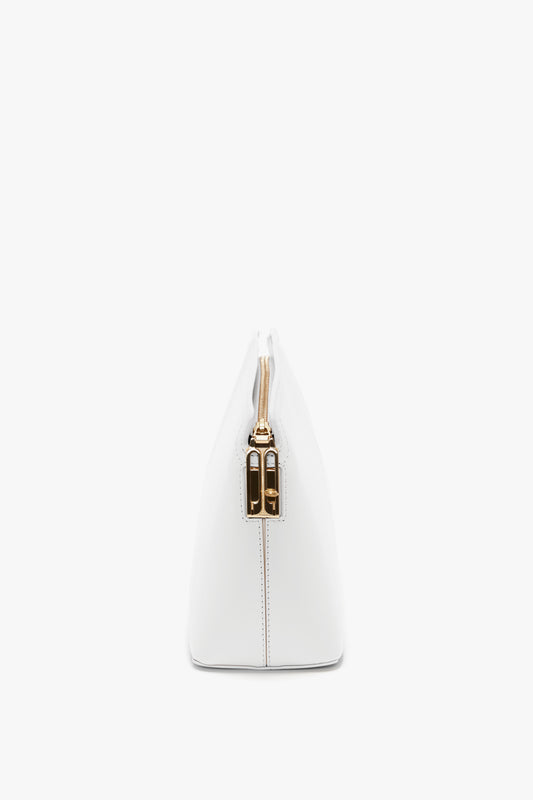 Side view of an Exclusive Victoria Clutch Bag In White Leather by Victoria Beckham with a gold clasp.