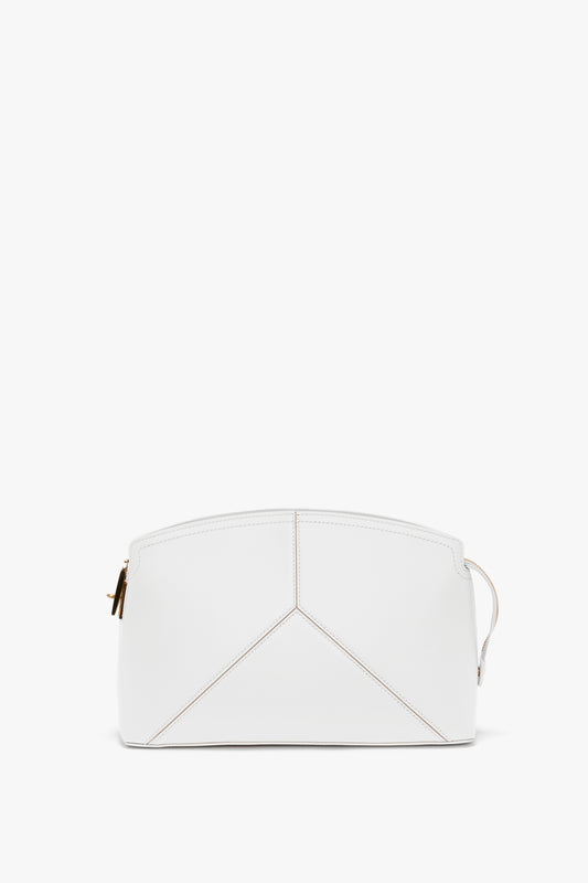 An Exclusive Victoria Clutch Bag In White Leather made of smooth calf leather with geometric stitching and a gold zipper, exuding the sophisticated elegance of Victoria Beckham.