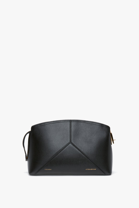 A Victoria Clutch Bag In Black Leather with minimal design and a zip closure, featuring subtle branding at the bottom, this piece boasts a structured silhouette by Victoria Beckham.