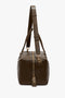 Side view of a brown leather duffel bag with gold-tone hardware and adjustable shoulder strap, perfect as a Victoria Beckham Medium Gym Bag In Olive.