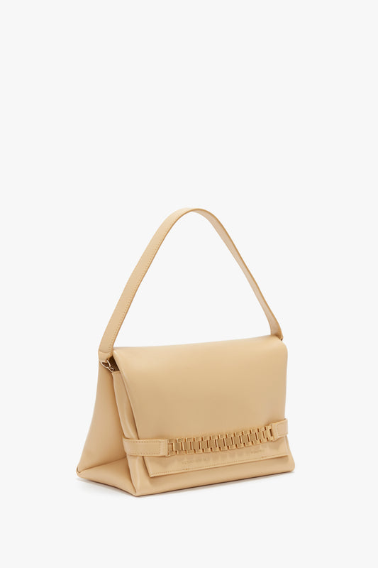 Beige leather crossbody bag with a sleek design, featuring a flat top handle and a horizontal strap detail on the front, Victoria Beckham Chain Pouch With Strap In Sesame Leather