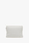 A white, rectangular Puffy Chain Pouch Bag With Strap In White Leather from Victoria Beckham is shown standing upright against a plain background, featuring a detachable shoulder strap for versatile styling.