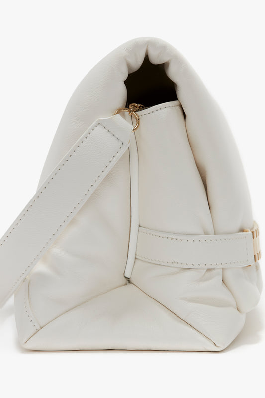 Close-up image of a white leather Victoria Beckham Puffy Chain Pouch Bag With Strap In White Leather, featuring a structured design, detachable shoulder strap, and gold hardware.