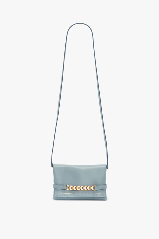 A Mini Chain Pouch Bag With Long Strap In Ice Leather by Victoria Beckham with a long strap and a gold-tone chain detail on the front.
