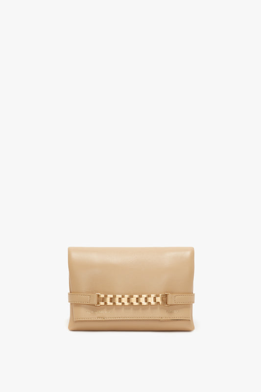 A Mini Pouch With Long Strap In Sesame Leather by Victoria Beckham with a decorative chain detail across the front, displayed against a white background.