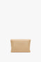 Victoria Beckham's Mini Pouch With Long Strap In Sesame Leather on a white background.