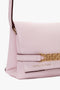 A chic Mini Chain Pouch Bag With Long Strap In Orchid Leather with a gold-tone chain detail and the text "Victoria Beckham" embossed on the front flap.