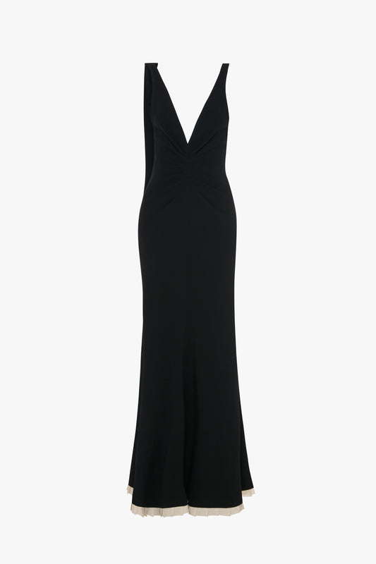 A black sleeveless V-Neck Gathered Waist Floor-Length Gown In Black by Victoria Beckham with a deep V-neckline and a slight ruffle at the hem.