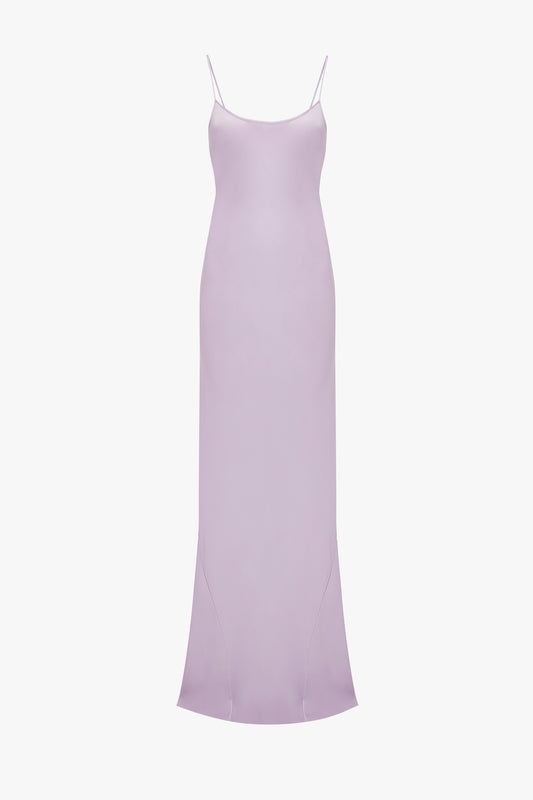 Victoria Beckham Low Back Cami Floor-Length Dress In Petunia with thin spaghetti straps and a smooth, flowing fabric. The dress has a subtle sheen and a form-fitting silhouette, reminiscent of 1990s style.