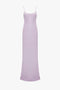 Victoria Beckham Low Back Cami Floor-Length Dress In Petunia with thin spaghetti straps and a smooth, flowing fabric. The dress has a subtle sheen and a form-fitting silhouette, reminiscent of 1990s style.