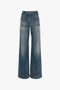 A pair of Victoria Beckham Alina High Waisted Jean In Indigrey Wash wide-leg blue jeans with seventies-style pockets and visible stitching on a white background.