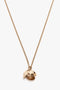 Exclusive Camellia Flower Necklace In Gold by Victoria Beckham, handcrafted in Italy, that appears to be in the shape of a partially open seed or pod, revealing a textured inner surface.