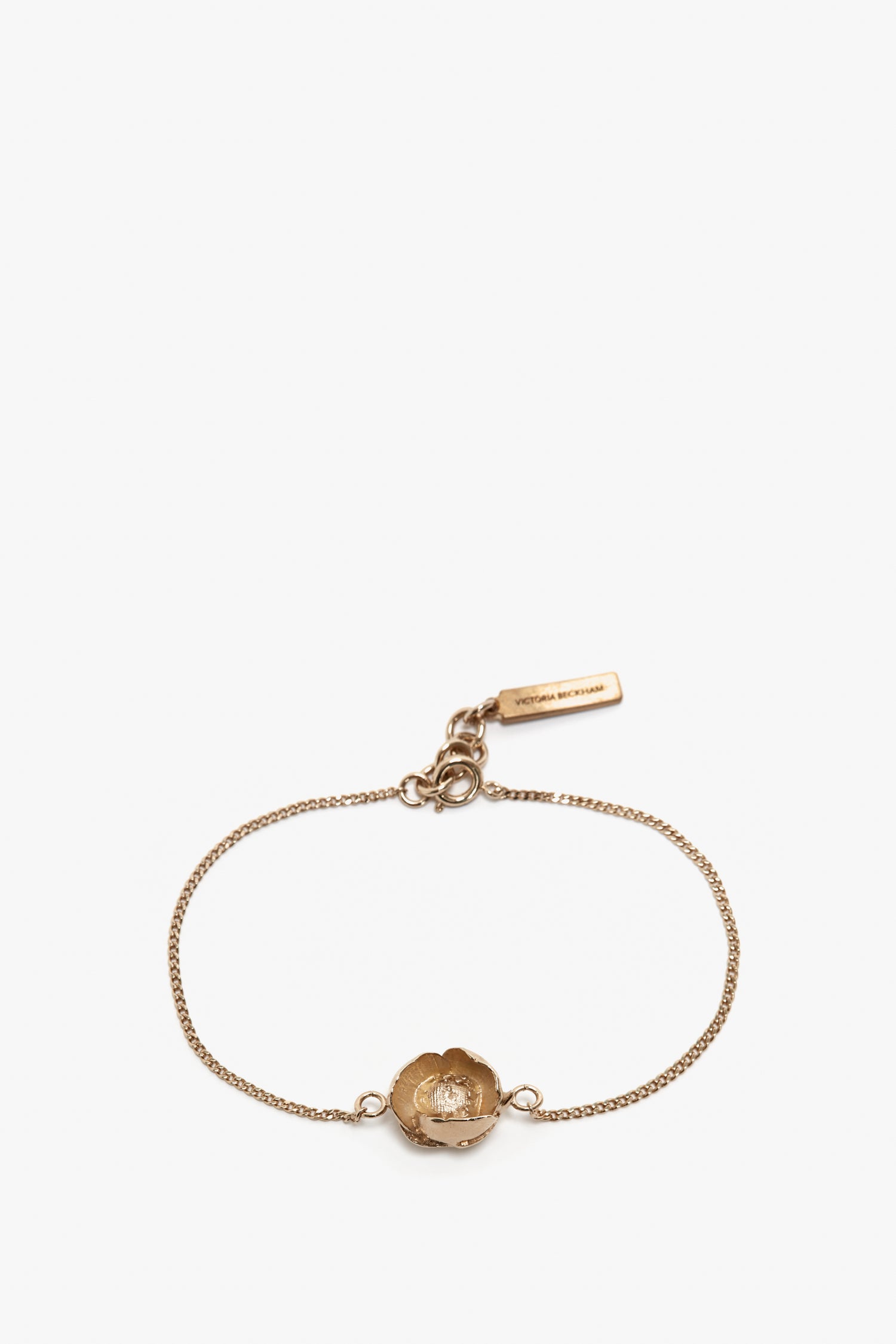 Exclusive Camellia Flower Bracelet In Gold by Victoria Beckham featuring a gold chain with an adjustable clasp and a flower-shaped charm at the center.