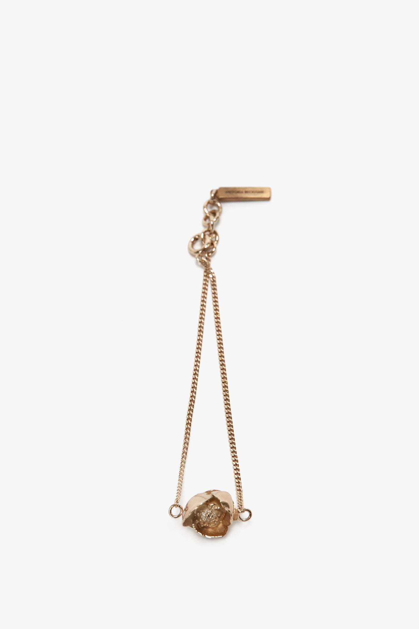 A Victoria Beckham Exclusive Camellia Flower Bracelet In Gold, featuring a rough-cut stone set in a simple pendant design, with an adjustable chain and clasp attachment at the top.