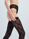 A person wearing black lace high-waisted underwear and Victoria Beckham Exclusive VB Monogram Lace Hold-Ups In Black with a sheer finish, photographed from the side against a plain background.