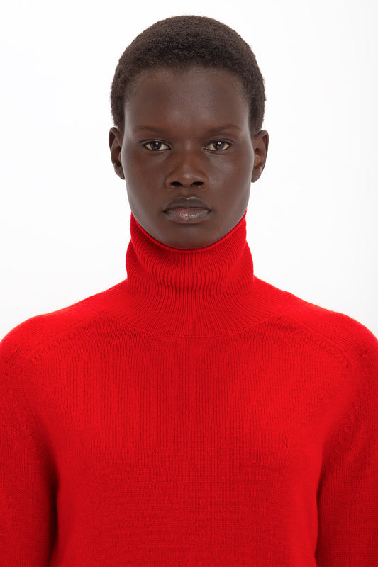 Person wearing a Victoria Beckham Polo Neck Jumper In Red, standing against a white background.