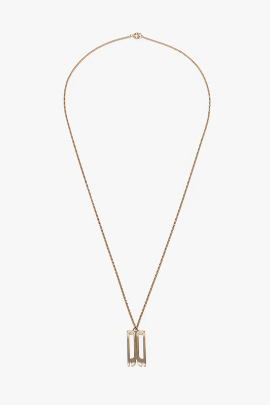 A delicate gold necklace featuring a thin chain and a double-bar pendant, this piece echoes the elegance of Victoria Beckham accessories. Crafted from gold-plated brass, it also incorporates a Victoria Beckham Exclusive Frame Necklace In Gold for added sophistication.