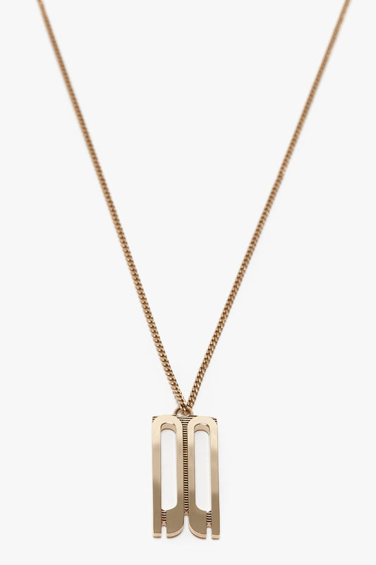 Exclusive Frame Necklace In Gold featuring a rectangular, cut-out design on a thin gold chain. This elegant piece, crafted from gold-plated brass, is perfect for those who appreciate simple yet sophisticated Victoria Beckham accessories.
