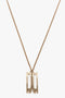 Exclusive Frame Necklace In Gold featuring a rectangular, cut-out design on a thin gold chain. This elegant piece, crafted from gold-plated brass, is perfect for those who appreciate simple yet sophisticated Victoria Beckham accessories.