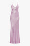 A long, sleeveless, pink satin Low Back Cami Floor-Length Dress In Rosa by Victoria Beckham with thin shoulder straps and a V-neckline, showcasing a sensuous silhouette.