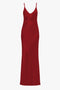 A long, poppy red, sleeveless gown with thin straps and a V-neckline offers a flattering fit that's reminiscent of the Victoria Beckham Low Back Cami Floor-Length Dress In Poppy Red.