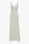 A long, Ruffle Detail Midi Dress In Ivory by Victoria Beckham featuring a fitted bodice, tactile lace detailing, and a flowing skirt.