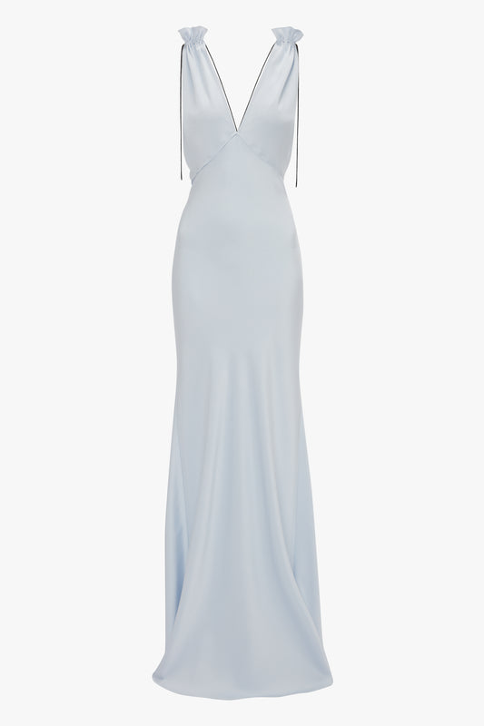 A floor-length Ice Blue crepe back satin dress, featuring a deep V neckline and thin gathered shoulder cami straps has been replaced with the **Exclusive Gathered Shoulder Cami Floor-Length Gown In Ice Blue by Victoria Beckham**.