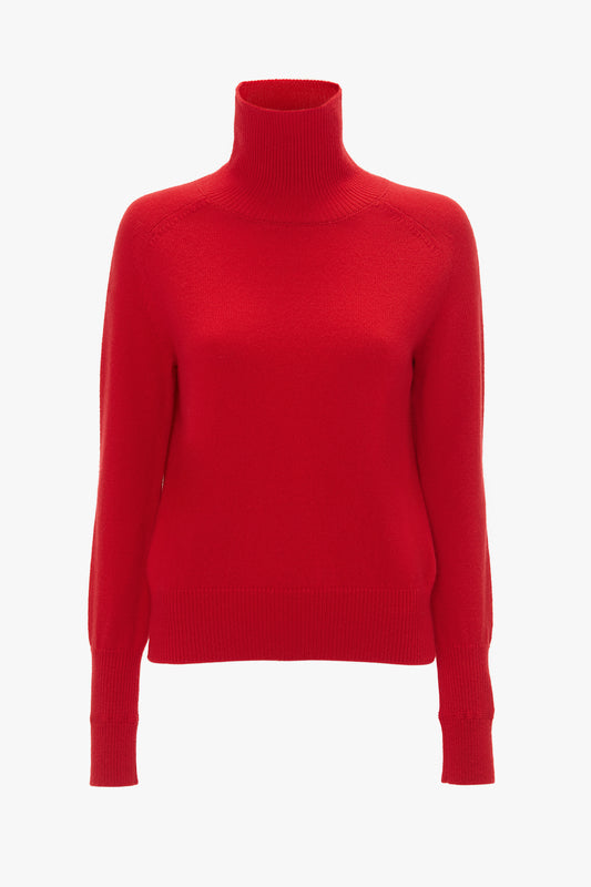 A bright red Polo Neck Jumper In Red by Victoria Beckham with long sleeves, ribbed cuffs and hem, embodying the essence of luxury knitwear.