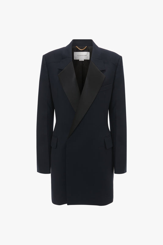 A black tailored blazer with a wide lapel, front pockets, and a single-button closure on a white background—perfect evening wear to pair with an Exclusive Fold Shoulder Detail Dress In Midnight by Victoria Beckham.