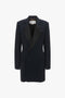 A black tailored blazer with a wide lapel, front pockets, and a single-button closure on a white background—perfect evening wear to pair with an Exclusive Fold Shoulder Detail Dress In Midnight by Victoria Beckham.