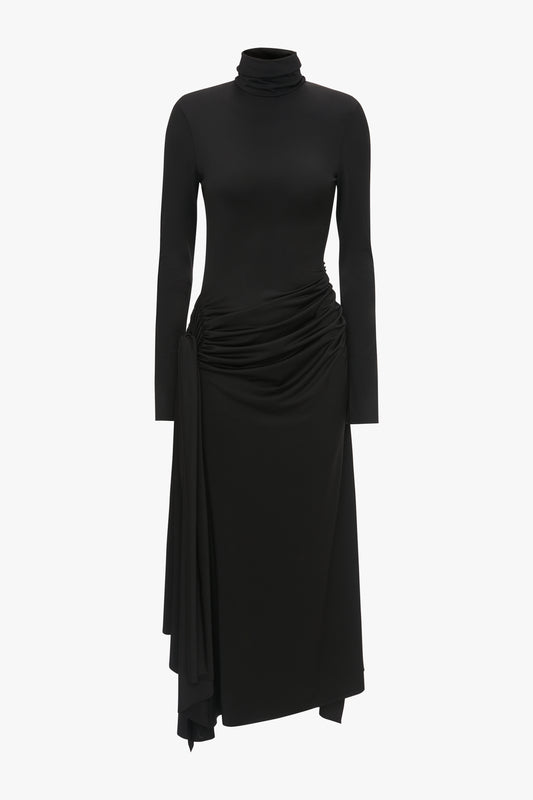A black turtleneck dress with long sleeves, featuring a draped skirt and a high neckline - Victoria Beckham's High Neck Asymmetric Draped Dress In Black.