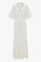 A white, short-sleeved, collared midi dress with a V-neckline and two chest pockets, exuding relaxed glamour in its lightweight knit: the Panelled Knit Dress In White by Victoria Beckham.